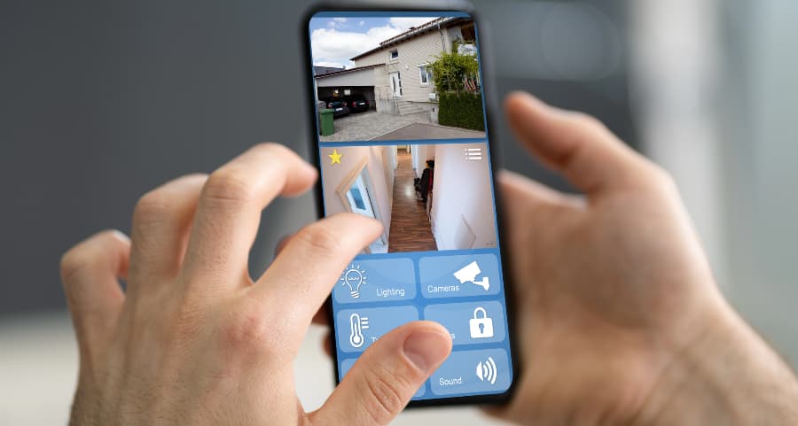 Homeowner examining video camera streams on a cell phone